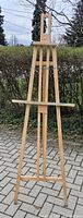 Full view of tall wooden easel standing outdoors