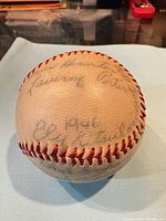 Overall view showing red stitching, leather surface and faded signatures