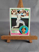 Front view of 1983 Topps #180 Rickey Henderson card on small easel