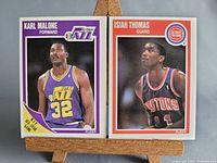 Front view of both Karl Malone and Isiah Thomas 1989 Fleer cards on stand