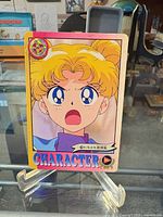 Front view of the Sailor Moon trading card on stand