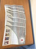 Five sealed packs of 9-pocket card pages on table