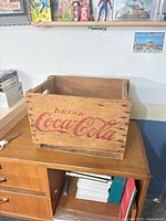 Overall view of wooden Coca-Cola crate front graphic