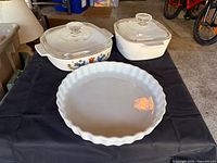 Lot overview showing both covered casseroles and pie dish