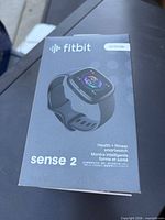 Sealed retail box front showing Fitbit Sense 2 branding and image