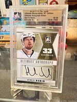 Full view of sealed Henrik Sedin Ultimate Autograph Silver card in holder