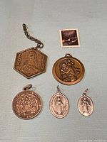 Group shot of all five medals showing size comparison and materials