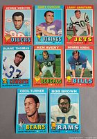 Fronts of 8 Topps football cards arranged on table