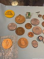Close-up of tokens, medal, pins and mixed coins