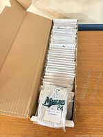 Open box showing row of individually bagged mini jerseys