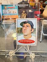 Front view showing portrait, red oval caption, dotted cut line