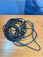 Coiled cables showing both black PVC and braided cloth types with multiple 1/4 in connectors