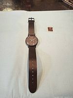 Full view of watch laid flat showing face and strap