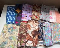 Top-down view of all 14 fabric pieces folded on table