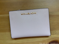front view showing gold Michael Kors logo and saffiano texture