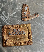 Front view of both wall plaques on stone surface