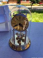 Front view of Westclox anniversary clock under glass dome