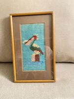Front view of framed pelican needlepoint