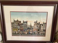 Overall view of framed print showing cityscape artwork, mat and frame