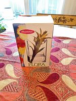 Front of boxed vase showing brand and Flora line