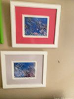 Two framed prints on wall showing frame colors and mats