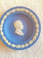 Front view showing blue plate with white portrait and laurel border