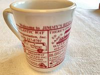 Full view of mug showing red advertising graphics