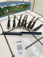 Full view of seven steak knives and sharpener