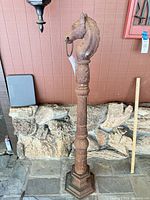 Full view of cast iron hitching post showing horse head, column shaft and base