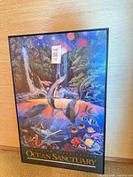 Full view of framed Ocean Sanctuary poster leaning against wall