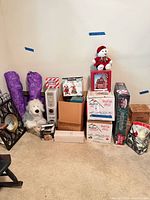 Overall view of stacked boxes, plush bear, heater, purple storage bags