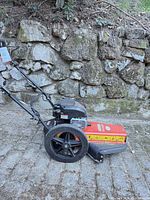 Full left-side view showing deck, wheels and engine