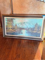 Full view of framed landscape painting