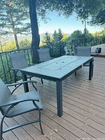 Full view of dining table with all four chairs around it on deck