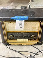 Front view of Grundig Classic radio showing dial, speaker cloth, buttons, power cord