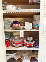 Cabinet shelf of bowls, plates and glass dishes