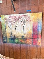 Full view of the landscape-oriented canvas painting mounted on wall