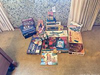Full lot overview showing board games, model kits, train set, books, DVD, puzzle