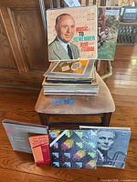Stack of LPs on chair with several covers visible