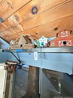 Shelf with multiple birdhouses including log cabin, barn and cottage styles