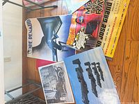 Group view of posters: Renaud piano, San Jose Grand Prix, aviation jets, vintage auto