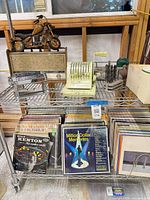 Overall lot view on wire rack showing radio, Paymaster, drills, records