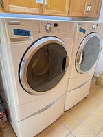 Washer and dryer side by side on pedestals