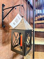 Lantern hanging from bracket on wall