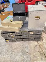 group shot of cabinet with drawers, three cash boxes stacked and large lock box