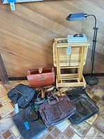 Overview of wood TV tray set, floor lamp, assorted bags and belts