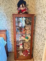 full view of cabinet and plush toys