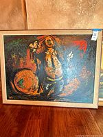 Full view of framed painting on floor