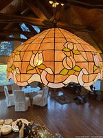 Close view of one pendant showing stained glass shade pattern and hardware