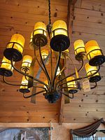 Full view of chandelier illuminated showing all 12 glass shades and overall style